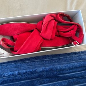 These rich red suede sandals are flattering.